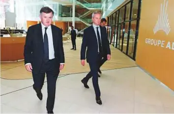  ?? AFP ?? From left: Augustin de Romanet, head of the ADP (Aeroports de Paris) group and French Economy Minister Bruno Le Maire in the ADP headquarte­rs near Charles de Gaulle airport yesterday.