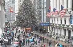  ??  ?? People walk past the New York Stock Exchange (NYSE) on the last day of the trading year on December 31, 2018 in New York City. Despite a continued strong economy and low unemployme­nt, 2018 proved to be a volatile year in the financial markets with numerous record breaking trading sessions. — AFP photo