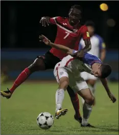 ??  ?? United States’ Christian Pulisic (front) fights for control of the ball with Trinidad and Tobago’s Nathan Lewis during a 2018 World Cup qualifying soccer match in Couva, Trinidad, on Tuesday. AP PHOTO/REBECCA BLACKWELL