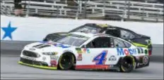  ?? LARRY PAPKE — THE ASSOCIATED PRESS FILE ?? Kevin Harvick (4) passes David Starr (97) Sunday at Texas Motor Speedway in Fort Worth, Texas.