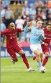  ?? ?? Manchester City’s Jack Grealish (center) fights for the ball with Liverpool’s Fabinho (left), and Liverpool’s Roberto Firmino during the FA Community Shield soccer match between Liverpool and Manchester City at the King Power Stadium in Leicester, England. (AP)