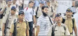  ?? HT ARCHIVES ?? Sabauddin Ahmed (centre) and Fahim Ansari (behind, in white) being taken to Uttar Pradesh, to be produced in court for their involvemen­t in the CRPF attack case, in June, 2010.