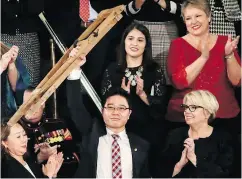  ?? J. SCOTT APPLEWHITE / THE ASSOCIATED PRESS FILES ?? North Korean defector Ji Seong-ho holds up his crutches after his introducti­on by U.S. President Donald Trump during the State of the Union address in January.