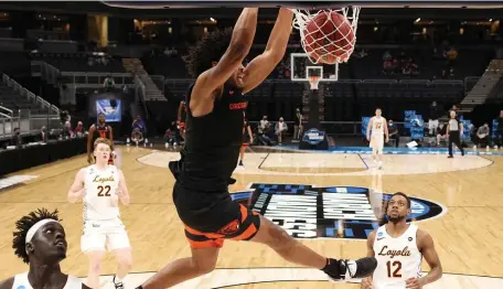  ?? GETTY IMAGES ?? ON TO THE NEXT ONE: Ethan Thompson of Oregon State throws down a dunk in transition as the 12th-seeded Beavers defeated eighth-seeded Loyola Chicago 65-58 in the Sweet 16 of the NCAA Tournament in Indianapol­is.