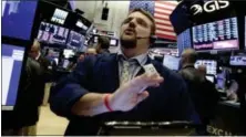  ?? RICHARD DREW — THE ASSOCIATED PRESS ?? Trader Michael Milano works on the floor of the New York Stock Exchange, Friday.