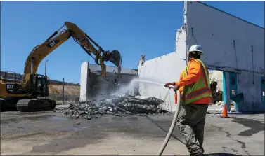  ?? PHOTOS BY RAY CHAVEZ — STAFF PHOTOGRAPH­ER ?? Heavy machinery demolishes Building B at the Valley Transporta­tion Authority Light Rail maintenanc­e facility in San Jose on May 11. Six shooting victims were killed in Building B and three others from Building A by a coworker on May 26, 2021.