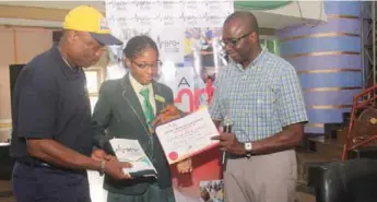  ??  ?? BFO Founder, Mr Owolabi, presenting a certificat­e to one of newly appointed ambassador­s while being assisted by another guest at the event