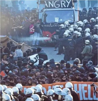  ?? THOMAS LOHNES, GETTY IMAGES ?? Police use water cannons and pepper spray against demonstrat­ors protesting the G-20 summit in Hamburg, where President Trump will meet with Vladimir Putin and other leaders.