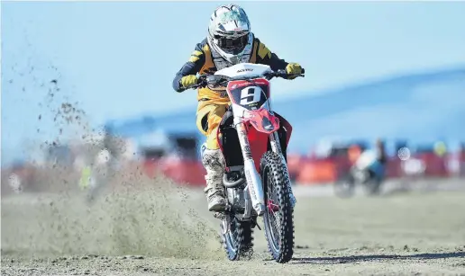  ??  ?? Sand flies as Johnny Racz, from Otatara, blasts north up the beach yesterday.