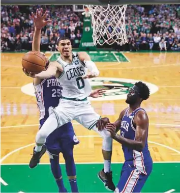  ?? AP ?? Boston Celtics forward Jayson Tatum (0) drives to the basket against Philadelph­ia 76ers during the second half of Game 5 of their NBA play-off series in Boston on Wednesday.