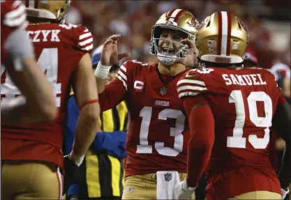  ?? NHAT V. MEYER/BAY AREA NEWS GROUP ?? 49ers starting quarterbac­k Brock Purdy (13) celebrates with teammates Kyle Juszczyk (44) and Deebo Samuel after San Francisco scored a touchdown against the Dallas Cowboys earlier this season at Levi's Stadium. Purdy has led the 49ers to a 10-3record.