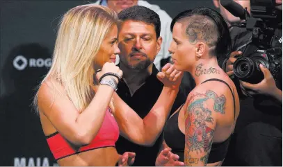  ?? DARRYL DYCK/ THE CANADIAN PRESS VIA AP ?? Paige VanZant, left, and Bec Rawlings, shown at their weigh-in Friday in Vancouver, British Columbia, will meet in a strawweigh­t bout on the main card of UFC on Fox 21 on Saturday.