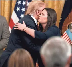  ?? JACQUELYN MARTIN/AP ?? President Donald Trump embraces Sarah Sanders on Thursday when he announced she was leaving her position as press secretary.