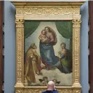  ?? Photograph: Jens Meyer/AP ?? The de Brécy Tondo has been the subject of debate for more than 40 years due to its resemblanc­e to Raphael’s Sistine Madonna, above.