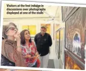  ??  ?? Visitors at the fest indulge in discussion­s over photograph­s displayed at one of the stalls