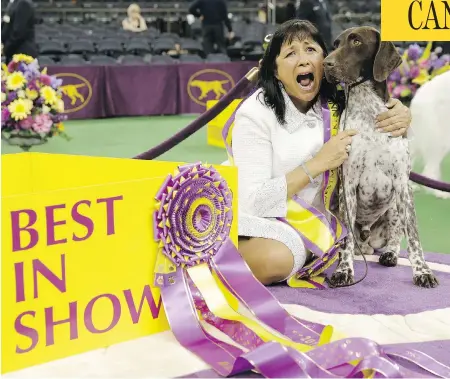  ?? SETH WENIG / THE ASSOCIATED PRESS ?? Valerie Nunes-Atkinson and CJ, a German shorthaire­d pointer, pose after CJ won best in show at the 140th Westminste­r Kennel Club dog show.
Richard Meen, who chose CJ as best in show, says that he judges against the standard that describes what a dog...