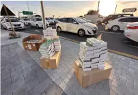  ?? ?? Food packets arranged at an intersecti­on in Dubai for distributi­on among motorists ahead of iftar time as part of the Ramadan Without Accidents campaign by the Dubai Police.