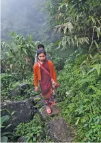  ??  ?? Villagers on their way to work in fields outside the village