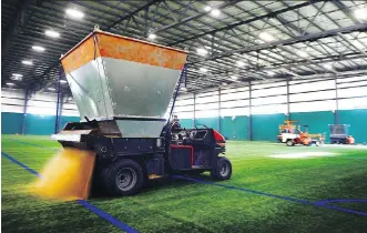  ?? RYAN McLEOD ?? FieldTurf puts the finishing touches on the new $11-million training facility in the city’s southeast for the Calgary Foothills Soccer Club on Friday. A grand opening celebratio­n will be held on June 24.