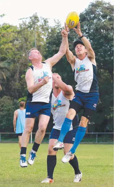  ?? Picture: JUSTIN BRIERTY ?? LEAP: Peter Harben, Mick Kowalczyk and Gavin Baguley train at Holloways Beach.