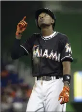  ?? PHOTO ?? Miami Marlins' Dee Gordon points to the sky after hitting a single during the fourth inning of a baseball game Monday against the New York Mets in Miami. AP