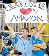  ?? AP/BOB LEVERONE ?? In mid-October, a Carolina Panthers fan shows his desire for Amazon to make Charlotte, N.C., its East Coast headquarte­rs before an NFL home game against the Philadelph­ia Eagles.