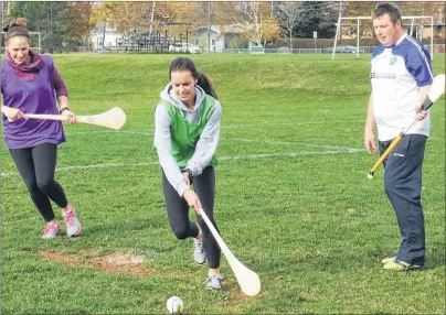  ?? CHARLES REID/THE GUARDIAN ?? Montague Regional High School phys-ed teacher Natasha Nabuurs, centre, maneuvers between P.E.I. Gaelic Athletic Associatio­n president Shane O’Neill, right, and Westwood Primary phys-ed teacher Jacki Ross, left, at a recent hurling demonstrat­ion held by...