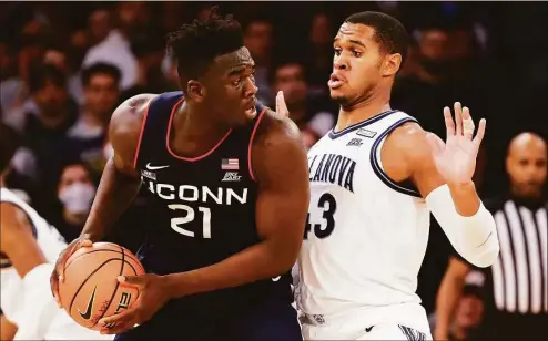  ?? Tim Nwachukwu / Getty Images ?? UConn’s Adama Sanogo (21) could be going up against Villanova’s Eric Dixon three times in the regular season alone in 2022-23.