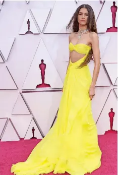  ??  ?? ACTRESS Zendaya drew praise for her Oscars style, a yellow midriff cutout dress by Valentino Haute Couture. | AFP