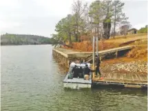  ?? ASSOCIATE PRESS FILE PHOTO ?? Alabama State Troopers arrive Dec. 14 to search for a missing victim after a vehicle drove off a boat landing in Cherokee County, Ala. Five people died, but the body of the fifth victim was not recovered until Wednesday.