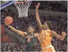  ?? RON IRBY/ASSOCIATED PRESS ?? Florida guard KeVaughn Allen shoots a layup past Tennessee forward Kyle Alexander during the first half of Saturday's game in Gainesvill­e, Fla.