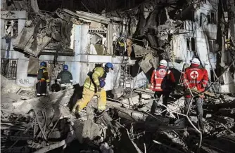  ?? Kateryna Klochko/Associated Press ?? Ukrainian state firefighte­rs inspect a damaged apartment building Thursday after Russian shelling in Zaporizhzh­ia, Ukraine. The Kremlin on Thursday blamed Ukrainian “terrorists” for crossing the border and attacking Russia’s Bryansk region.