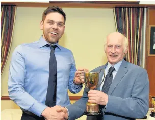  ??  ?? ● Richard Williams of J Williams & Son, Portreuddy­n, Tremadog (right) receiving the Buttington Perpetual Challenge Cup from youngstock judge Geraint Jenkins