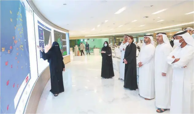  ?? ?? ± Mariam Bint Mohammed Almheiri, Minister of Climate Change and Environmen­t, tours the National Centre of Meteorolog­y in Abu Dhabi.