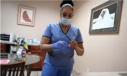  ?? Photograph: Robyn Beck/AFP/Getty Images ?? A medical assistant checks a patient's pregnancy test result at a clinic in Santa Teresa, New Mexico.