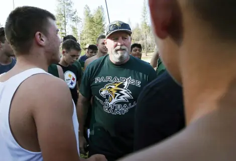  ?? RICH PEDRONCELL­I — THE ASSOCIATED PRESS ?? Rick Prinz, center, coach of the Paradise High School football team, meets with his players after practice in Paradise. Paradise’s game against Williams High School on Friday will be the first game for the team since a wildfire nearly destroyed the foothill community last year. Prinz said the team has 35 players, down from 56 last year as the school has lost nearly half of its students who moved away.