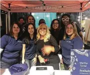  ??  ?? MTSIR Woodlands agents (front row, l to r)Marla Bailey, Elyse Bayer, Amy Yoder and Sabrina Gudino joined other Woodlands Chamber volunteers supporting the Taste of the Town there.