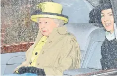  ??  ?? Queen in her yellow outfit in her car outside church yesterday