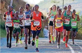  ?? [PHOTO COURTESY OF ANDRE HARMSE] ?? Camille Herron, Oklahoma native and world-class ultrarunne­r, is surrounded by male elites during the Comrades Marathon earlier this month. She won the women’s division by more than four minutes and finished 63rd overall.