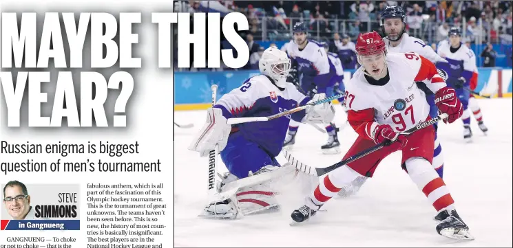  ?? GETTY IMAGES ?? Nikita Gusev of Olympic Athletes from Russia tries to control the puck as Slovakia goalie Branislav Konrad stands guard during their men’s preliminar­y round Group B game in Gangneung, South Korea, yesterday. The Russians haven’t won gold since 1992.