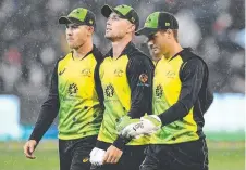  ?? Picture: GETTY IM ?? CANNED: D'Arcy Short, Ben McDermott and Alex Carey walk off the field as rain starts again.