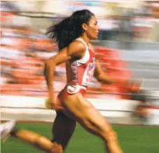 ?? Lennox Mclendon / Associated Press 1988 ?? Florence Griffith Joyner sets a world record in a 200-meter semifinal in Seoul in the 1988 Olympics.