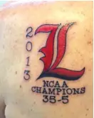  ??  ?? After Louisville won the 2013 national championsh­ip, then- coach Rick Pitino had this tattooed on his left shoulder.