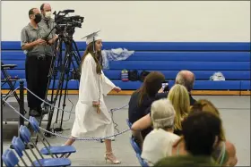  ?? BEN HASTY — MEDIANEWS GROUP ?? Daphney Langdon, 18, president of the Class of 2020at Oley Valley High School, walks to the stage to get her diploma Wednesday. The district held graduation ceremonies for the seniors one at a time because of the COVID-19crisis.