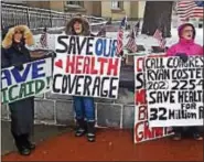  ?? BILL RETTEW — DIGITAL FIRST MEDIA ?? Citizens hold signs as they rally for health care outside the West Chester office of U.S. Rep. Ryan Costello March 10.