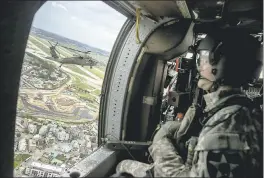  ?? ANDREW HARNIK — THE ASSOCIATED PRESS ?? A helicopter carrying Joint Chiefs Chairman Gen. Joseph Dunford and U.S. Forces Korea Commander Gen. Vincent Brooks, left, flies Sunday near Pyeongtaek, South Korea.