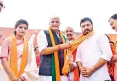  ?? — DC ?? TRS leader V. Mohan Reddy and advocate Rachana Reddy join the BJP in the presence of Union minister Gajendra Shekhawat and BJP state president Bandi Sanjay Kumar at Yadadri on Tuesday.