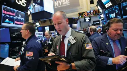  ?? (Andrew Kelly/Reuters) ?? TRADERS WORK on the floor of the New York Stock Exchange yesterday. The Dow Jones Industrial Average scaled its 11th consecutiv­e record high on Friday, the longest such run since 1987, leading some to suggest it could be ready for a correction.