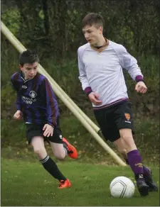  ??  ?? Jacob Wasilewski of Wexford Albion considers his options as Cillian Egan (Courtown Hibs) moves in.