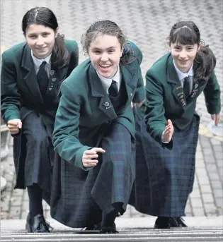  ?? PHOTOS: PETER MCINTOSH ?? Eyes on the prize . . . Columba College pupils (from left) Megan Macdiarmid, Laura Canton and Olivia Charles hope to win an internatio­nal app design competitio­n for young women in technology. Right: The On Track Dunedin app designed by the three...